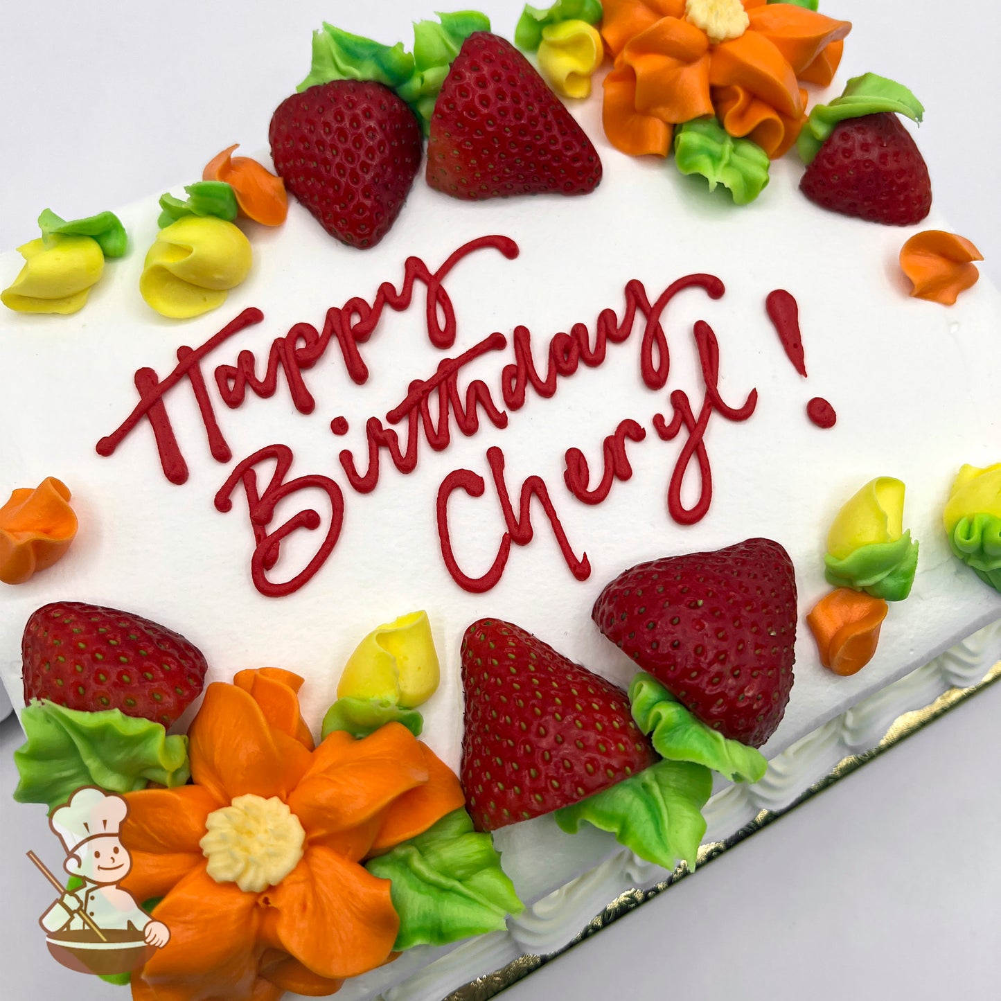 Sheet cake with white frosting, decorated with fresh strawberries, orange buttercream flowers, and yellow and green floral accents.