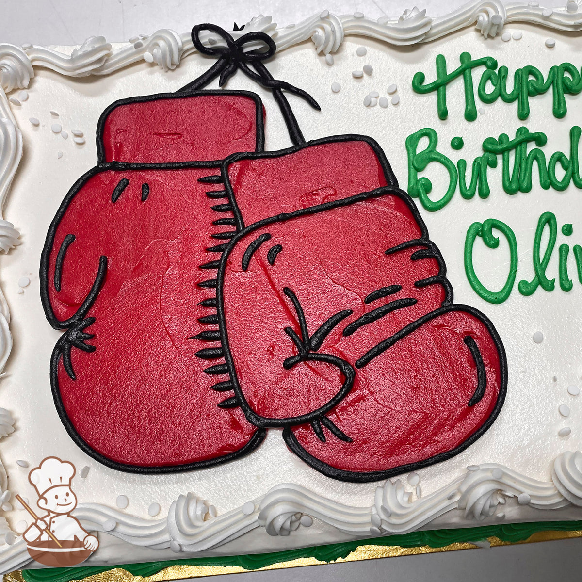 Sheet cake with red buttercream boxing gloves, outlined in black. White buttercream border with small white sprinkles.