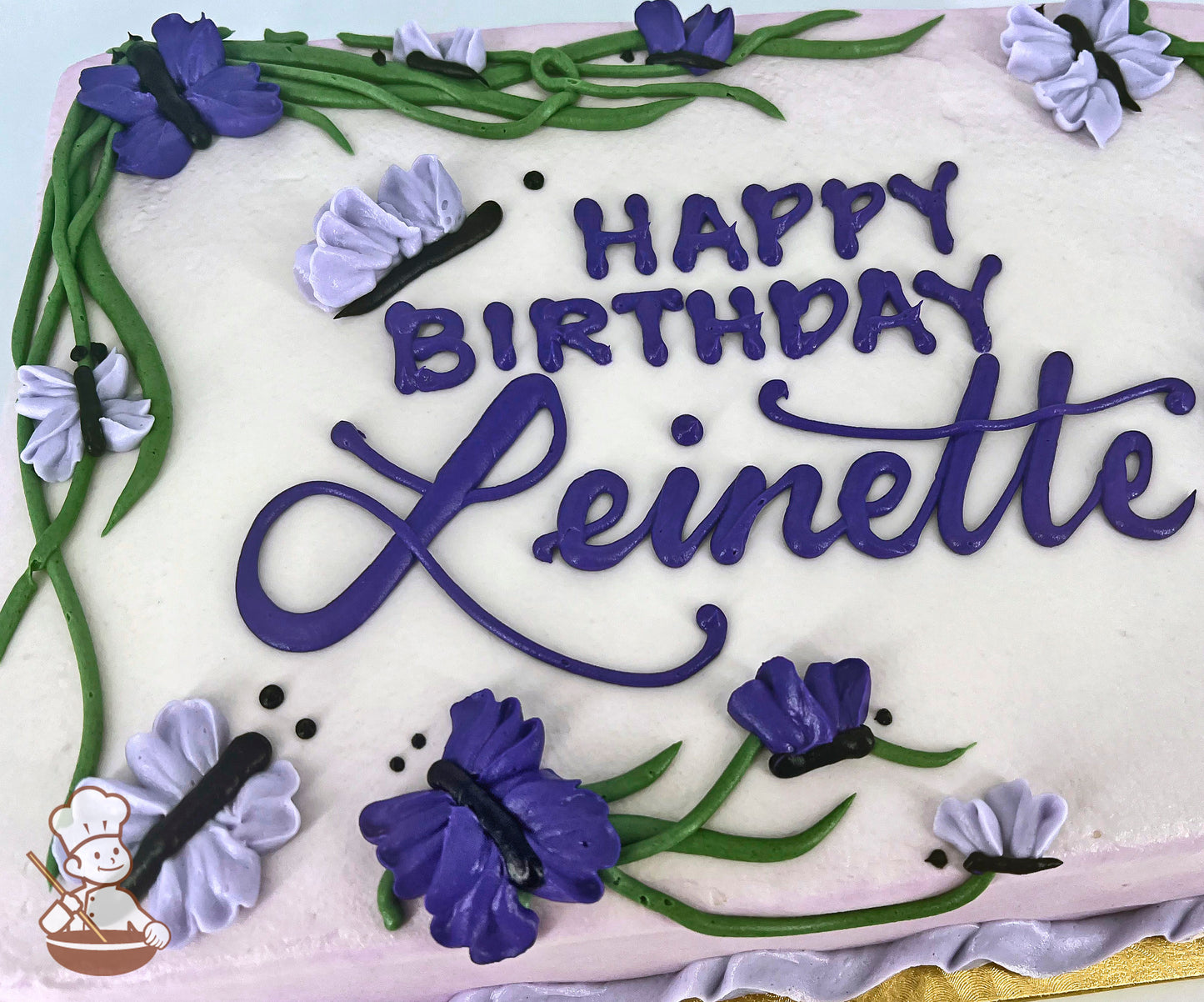 Sheet cake with purple and lavender buttercream butterflies and green vines decorations.