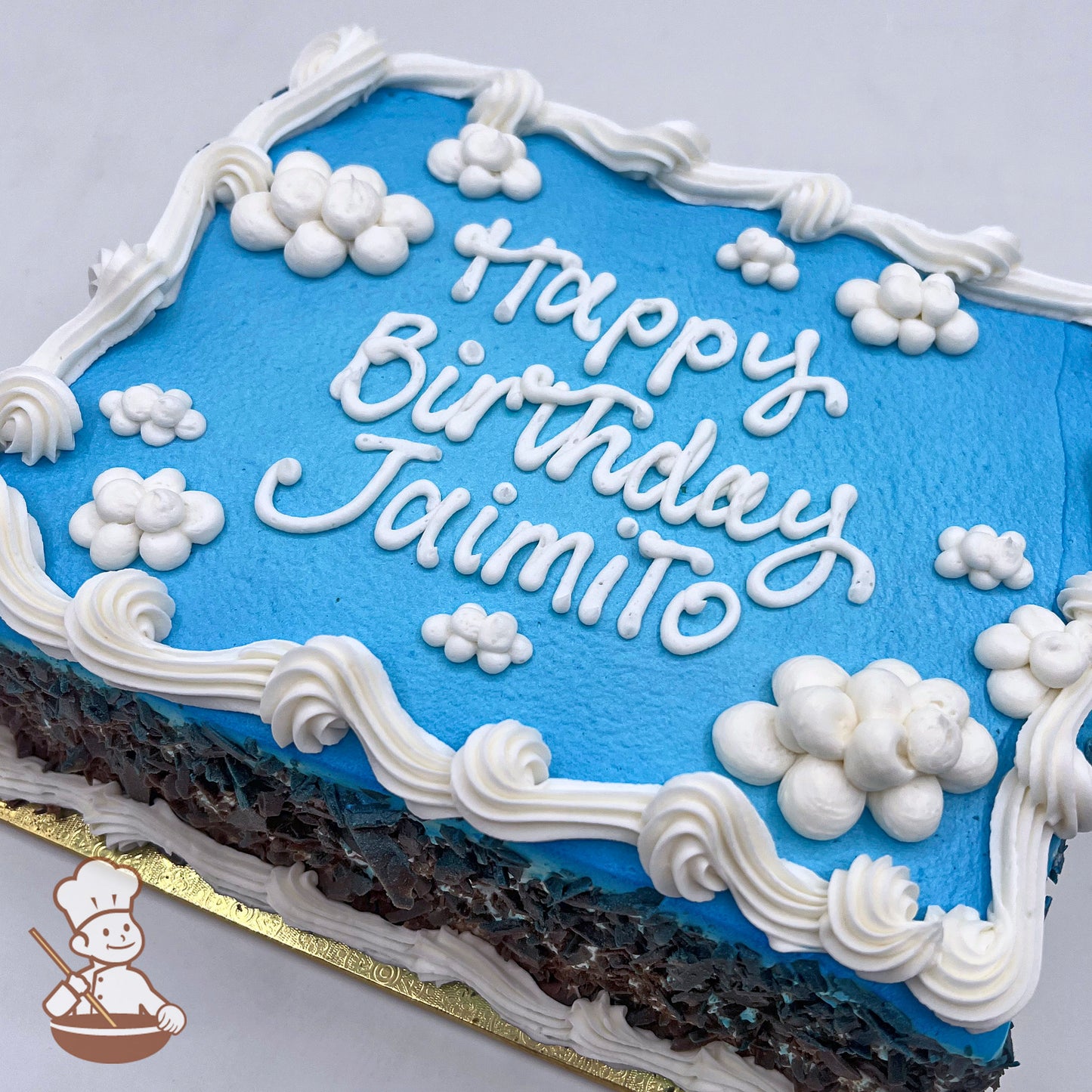 Blue sheet cake with white buttercream clouds and swirled border.