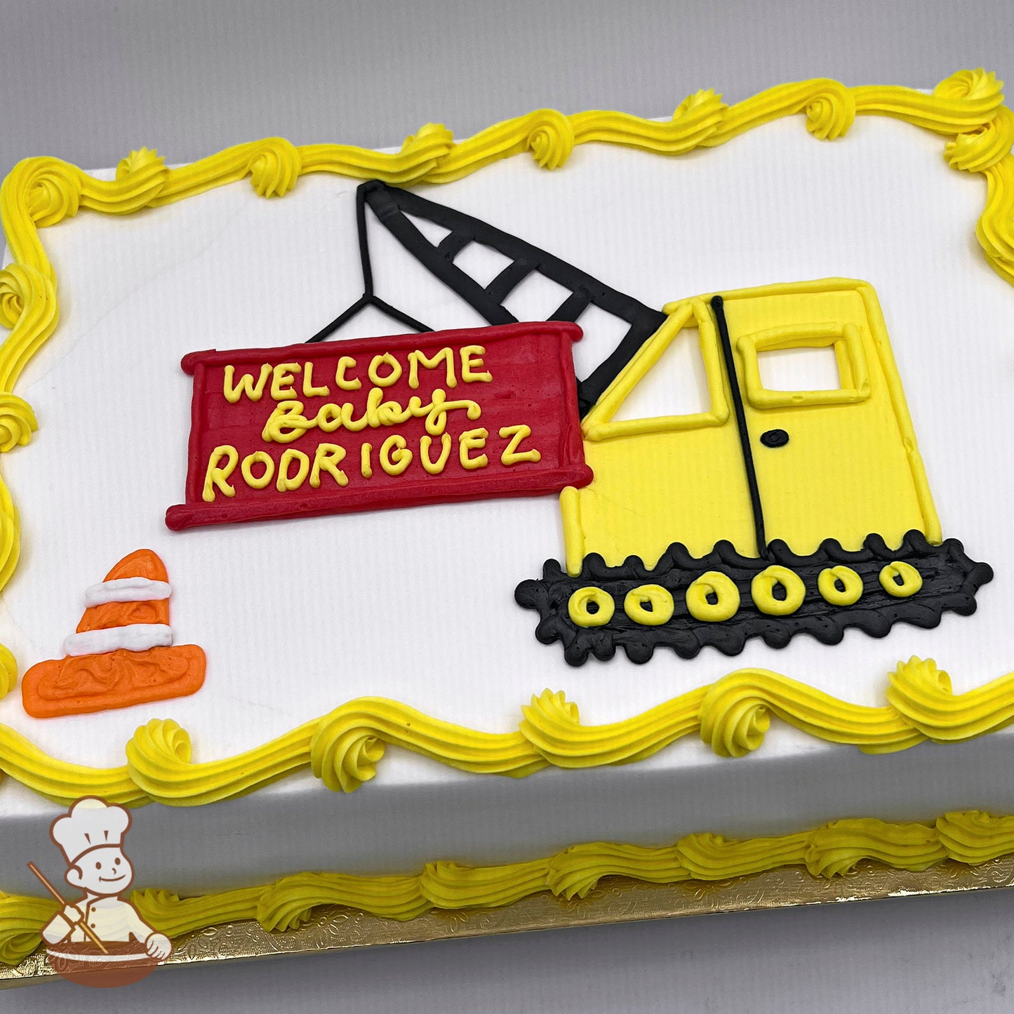 Sheet cake with yellow buttercream borders, a yellow construction vehicle with black tracks, a red sign, and an orange traffic cone decoration.