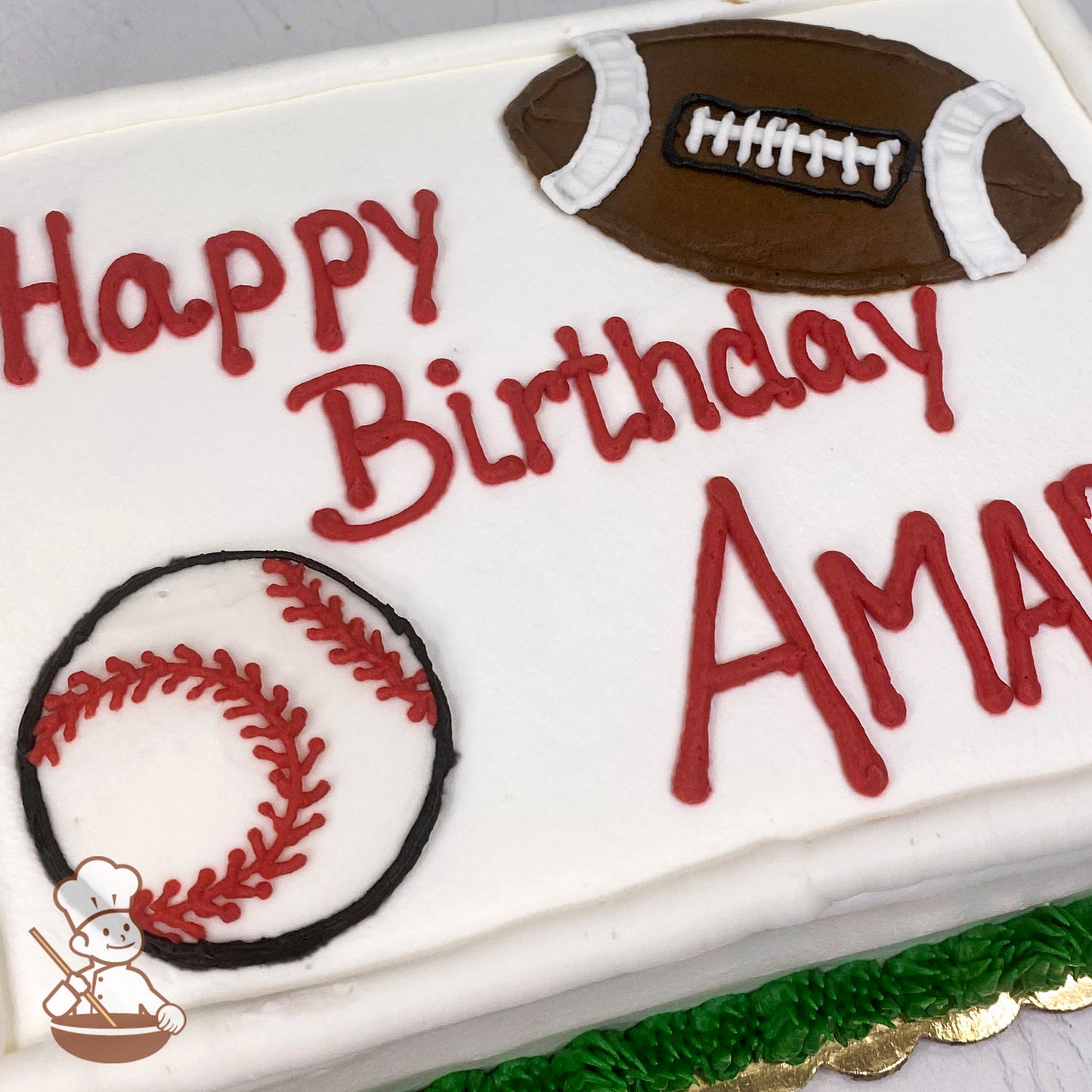 Sheet cake with white frosting, decorated with a hand-piped brown football and red-stitched baseball. Green frosting border at the base.