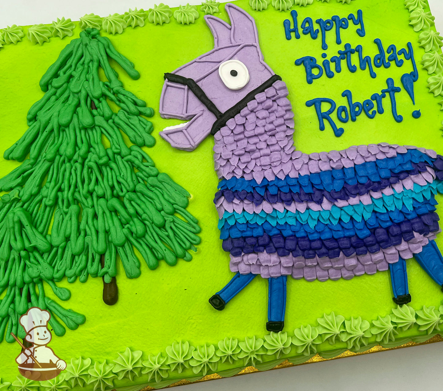 Sheet cake with bright green frosting, featuring a piped Fortnite llama in purple, blue, and teal, and a green buttercream tree.