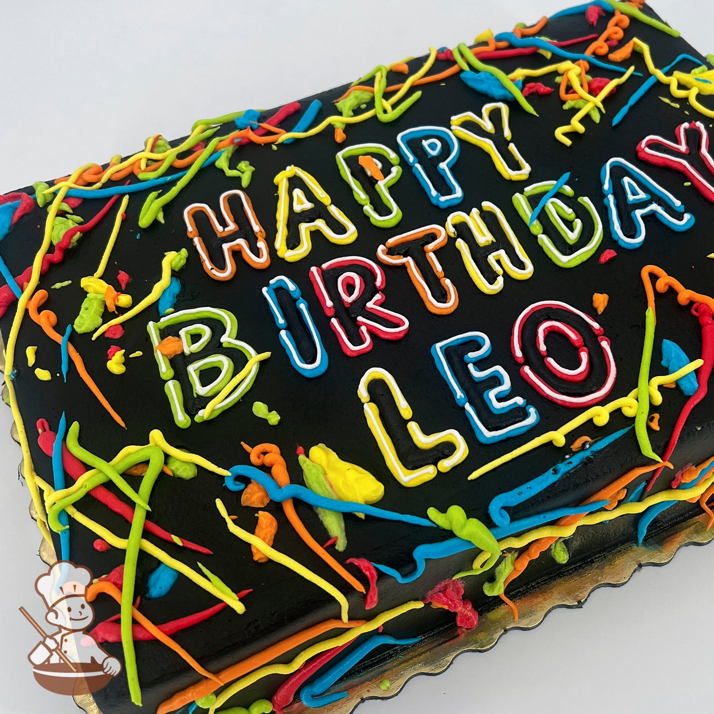 Black sheet cake with colorful "glow-in-the-dark" buttercream splatters and streamers.