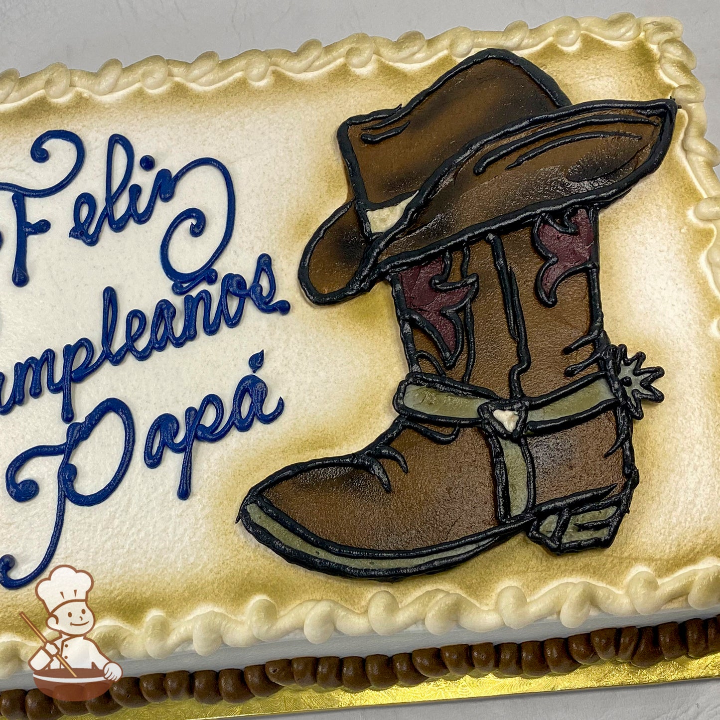 Sheet cake with buttercream cowboy boot and hat decoration, bordered with piped icing.