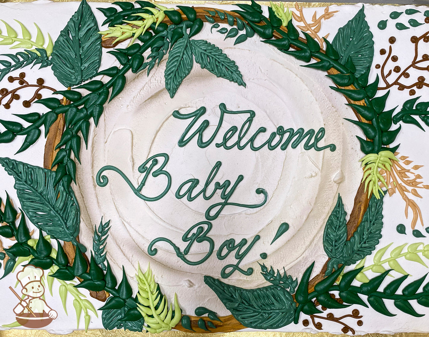Sheet cake with white frosting, decorated with a jungle-themed frame of green leaves, vines, and small brown and floral accents.