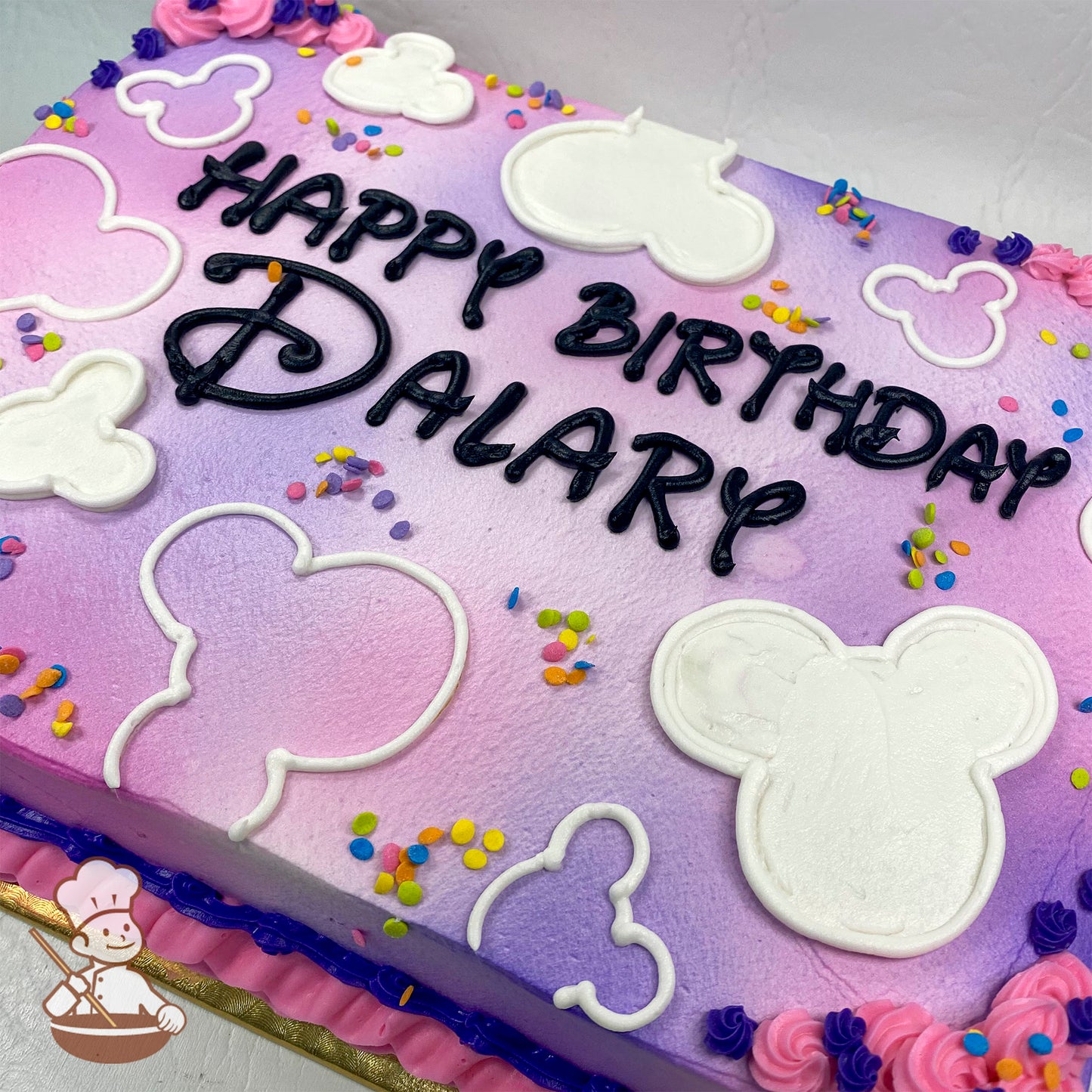 Sheet cake with pink and purple gradient, white Mickey head outlines, colorful sprinkles, and pink floral accents.