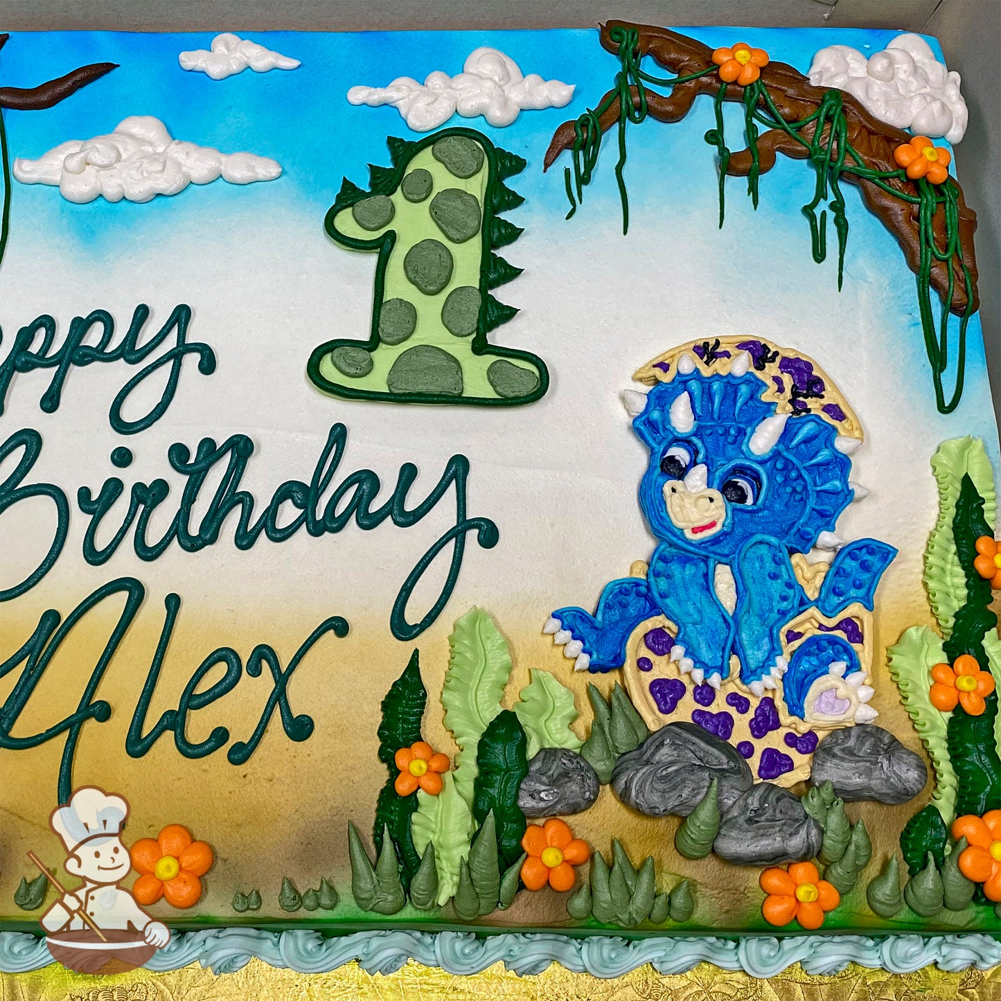 Sheet cake with buttercream decorations featuring a blue Triceratops, green plants, orange flowers, gray rocks, fluffy clouds, and a tree branch with vines.