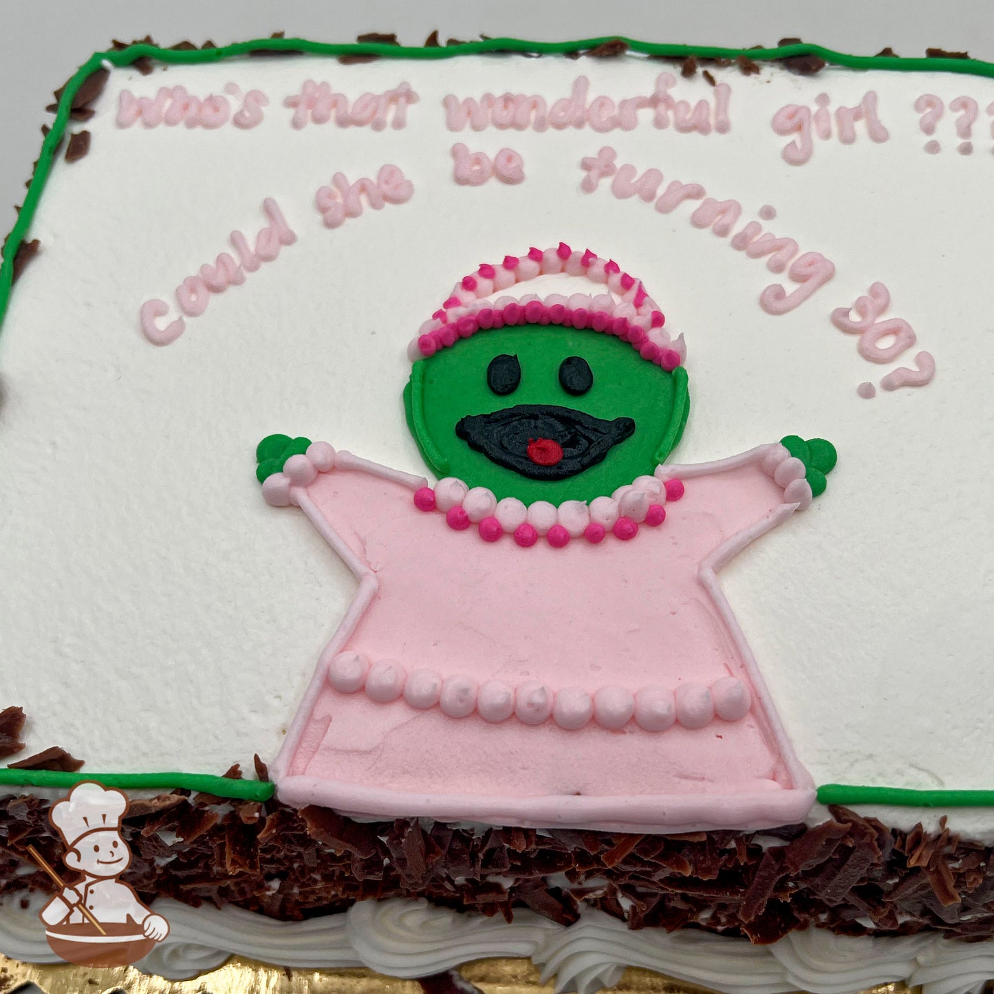Sheet cake with white frosting, and green border. Center features a green buttercream figure in a pink dress, pearls, and a tiara.