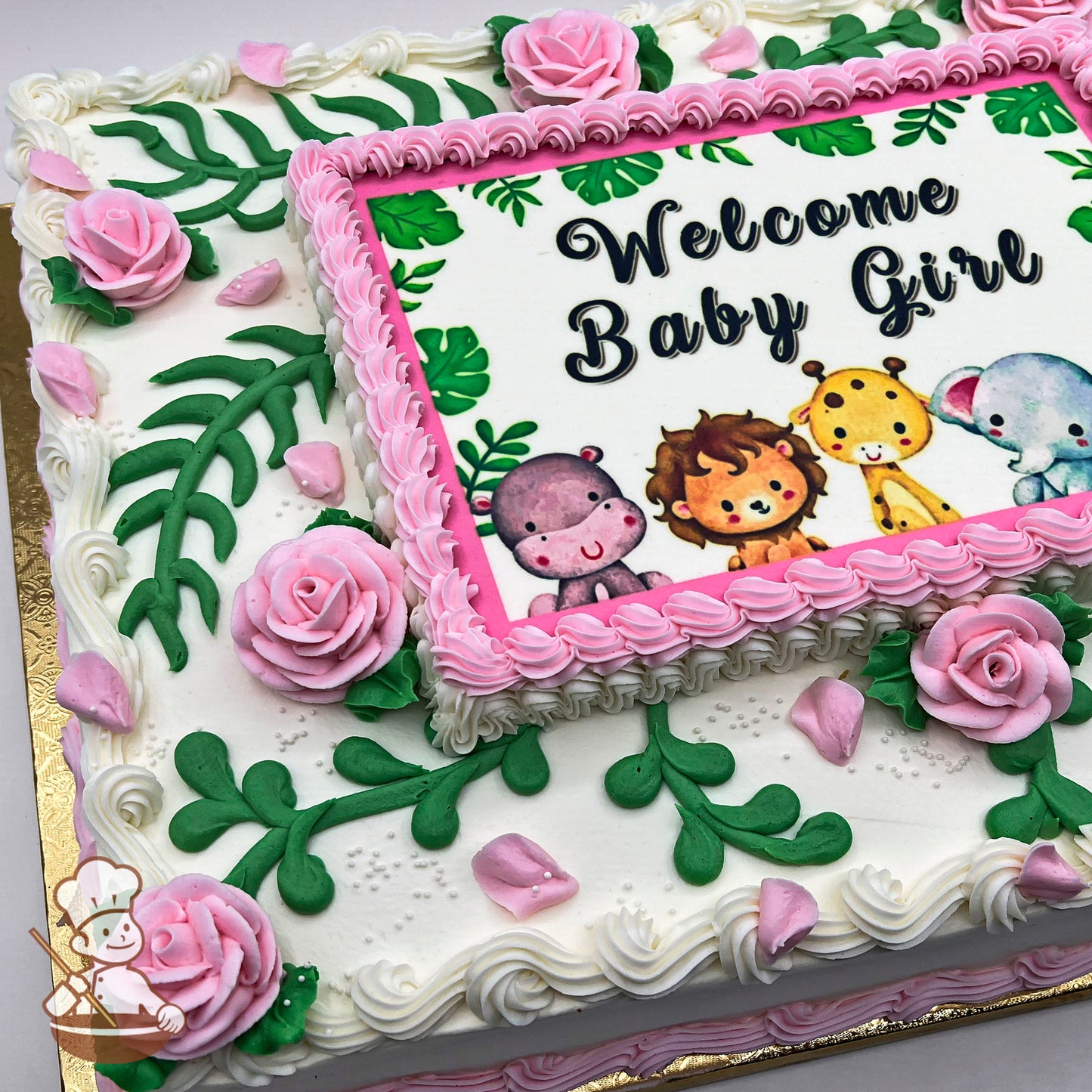 Sheet cake with pink buttercream roses, green fern-like leaves, and scattered pink petals. The border features pink piping, framing a central printed design.