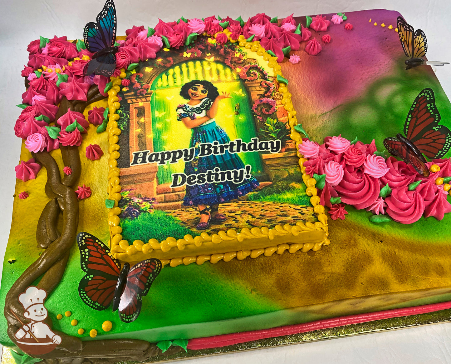 Sheet cake with colorful buttercream rosettes, hand-piped tree with flowers, and plastic butterflies. Bright, vibrant design surrounds a central image.