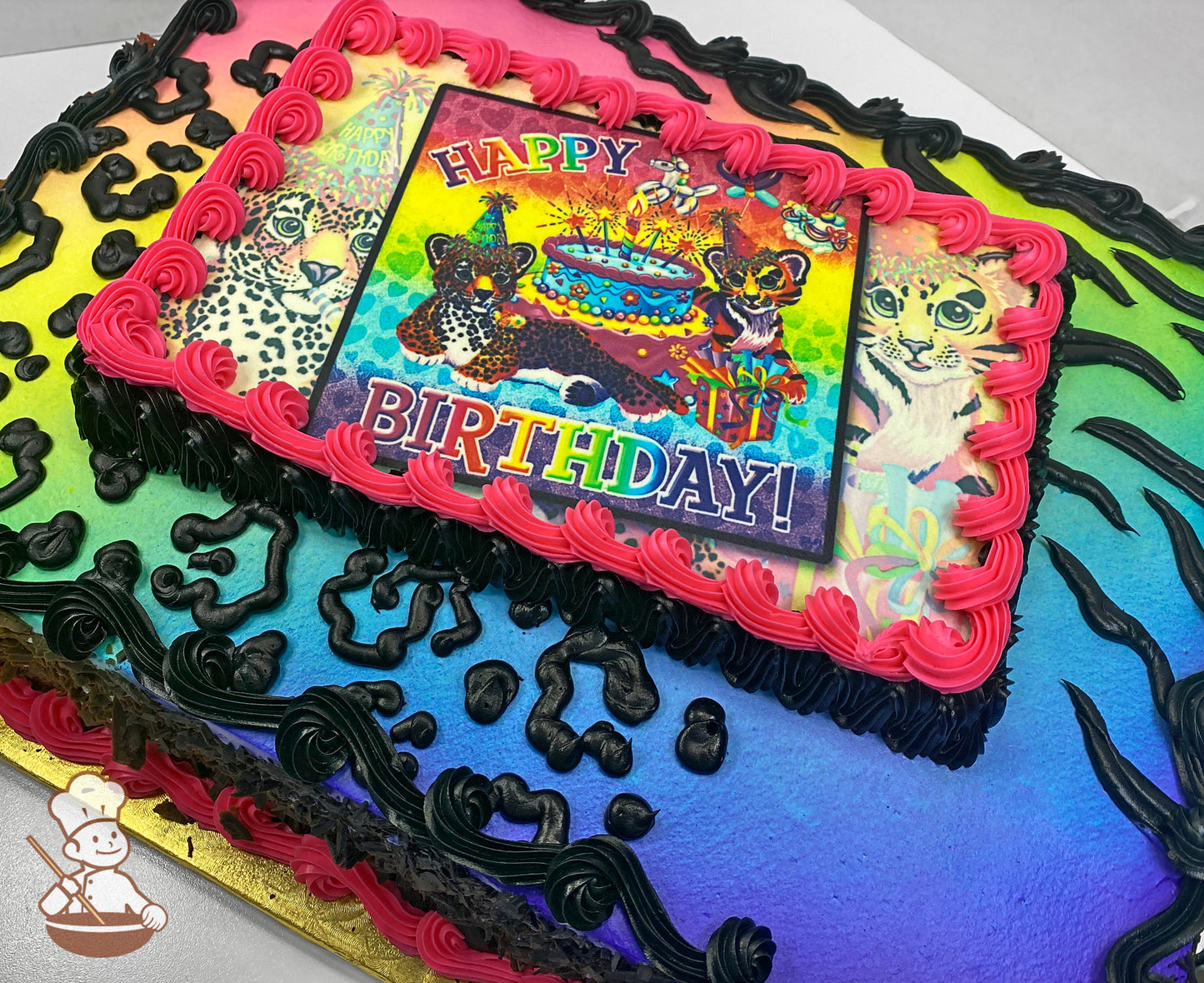 A sheet cake with a vibrant rainbow gradient background, black animal print patterns, and a pink buttercream border surrounding a central printed design.