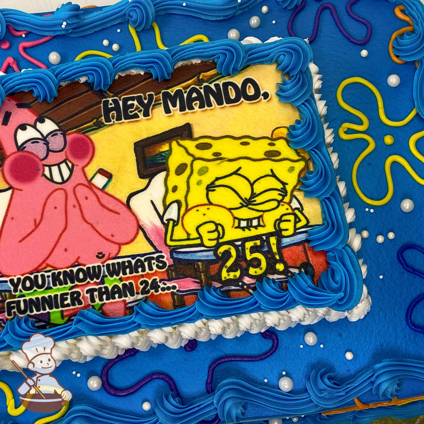 Sheet cake with blue frosting, SpongeBob flower clouds in yellow, pink, and purple, pearl bead sprinkles, and a printed photo layer bordered by blue piping.