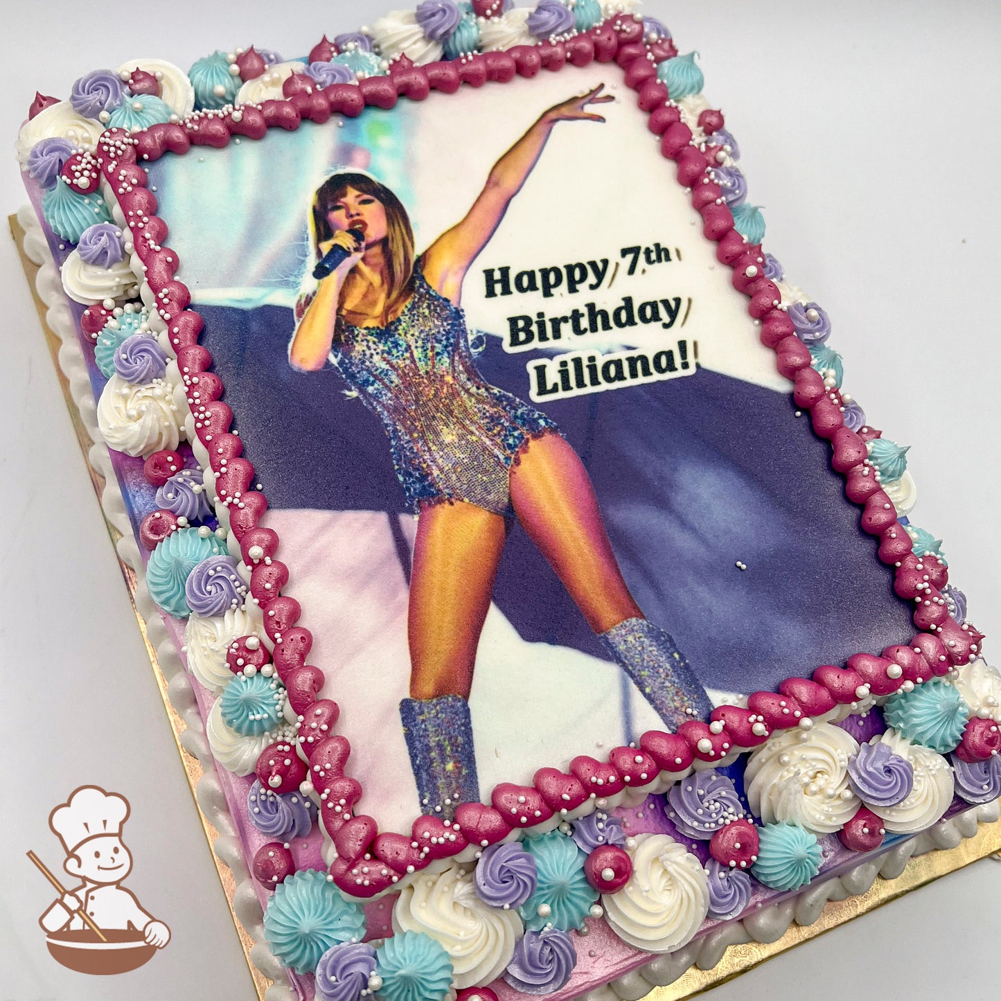 Sheet cake with a printed photo layer, bordered by pink pearl buttercream bead trims, pastel buttercream swirls in purple, blue, and white, and small white sprinkles.