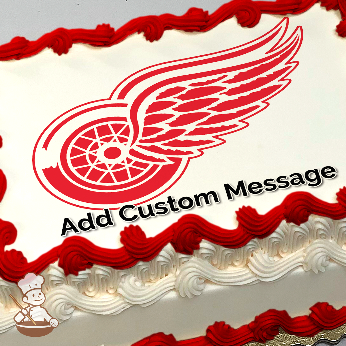 Red and white winged wheel logo on a sheet cake, with a space for a custom message above.