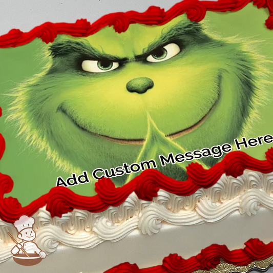 Grinch with mischievous smile printed on extra cake layer and decorated on sheet cake.