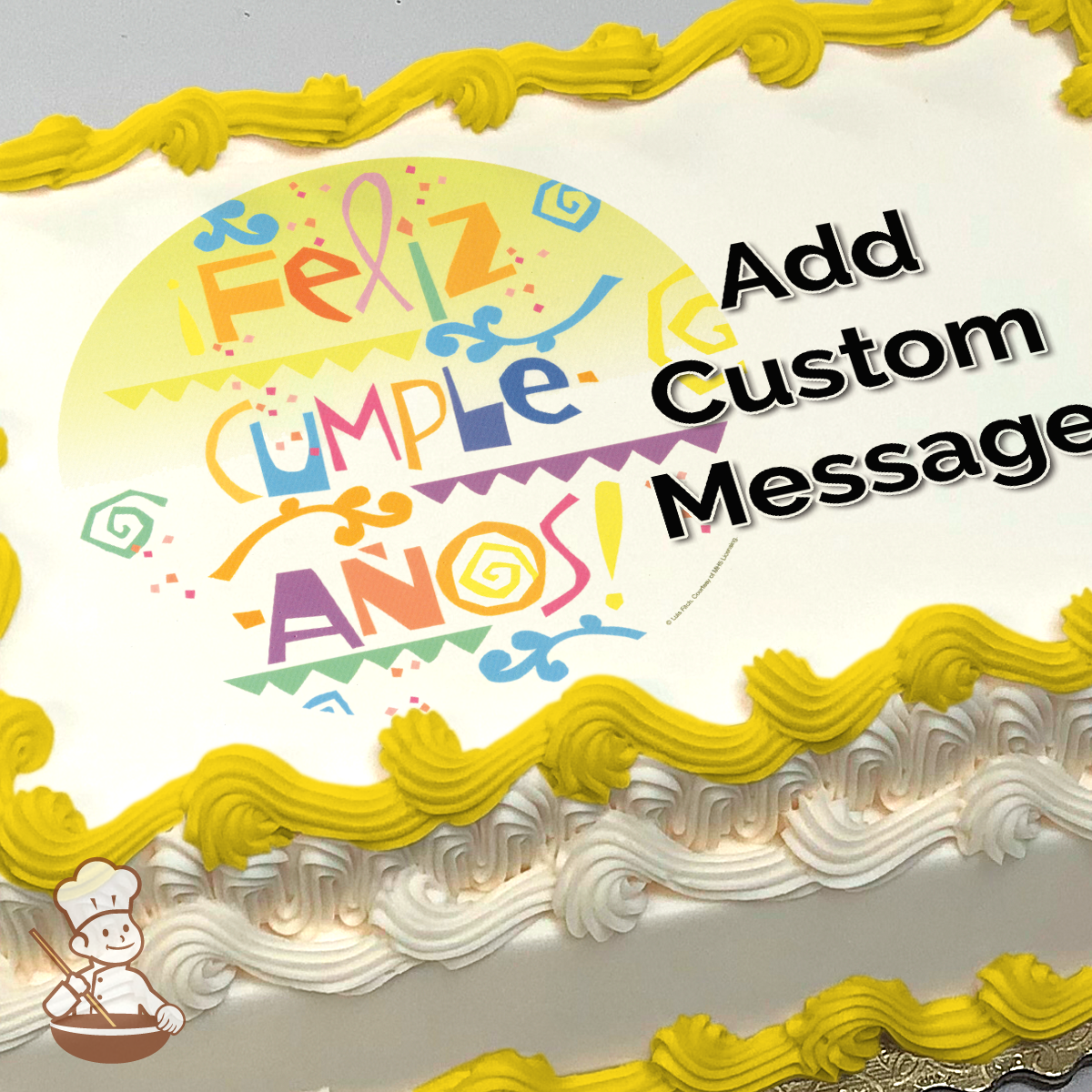 Colorful "Feliz Cumpleaños" message with festive designs printed on a cake.