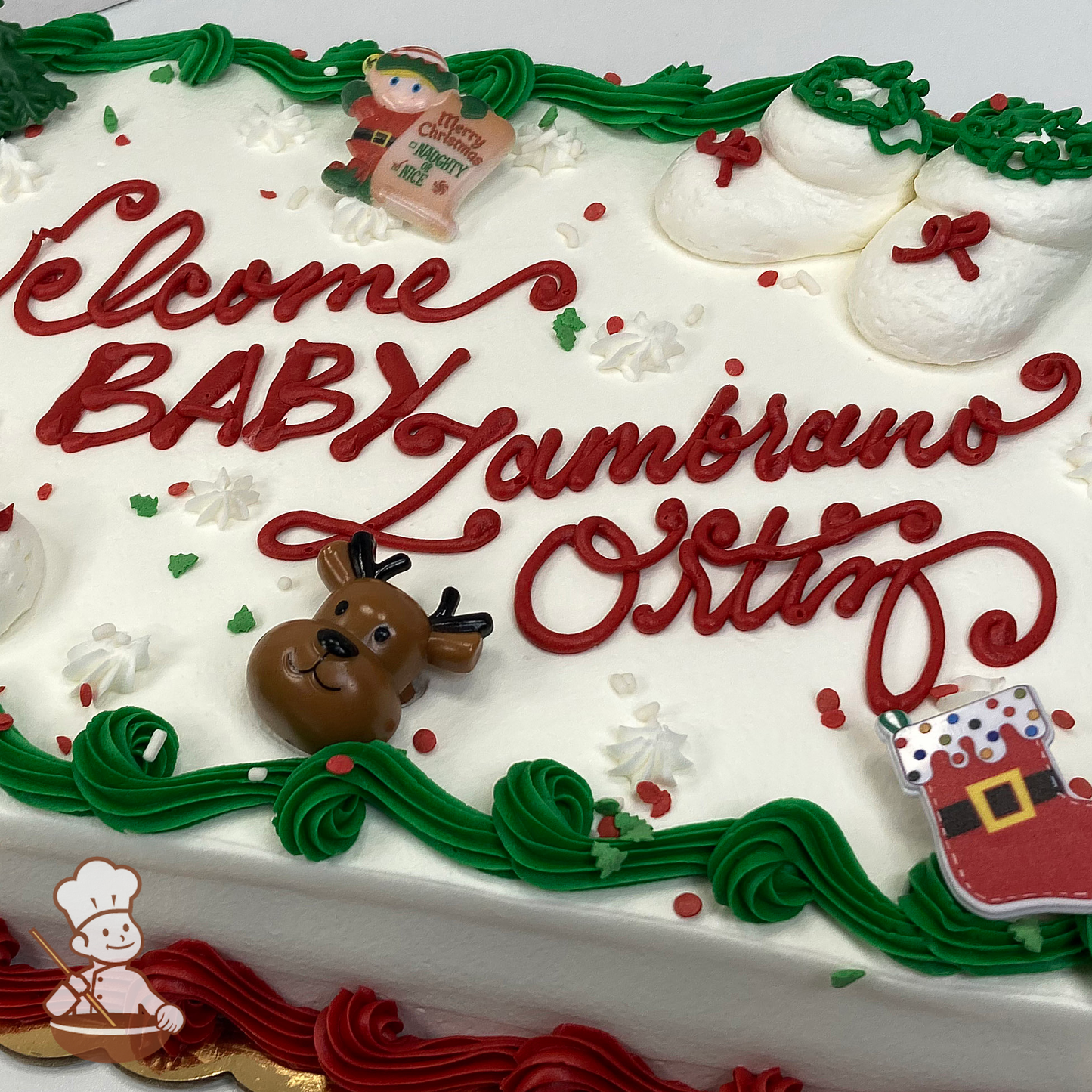 Baby shower sheet cake with baby bootie shoes and sprinkles; and Christmas Elf, stocking and reindeer toy rings.