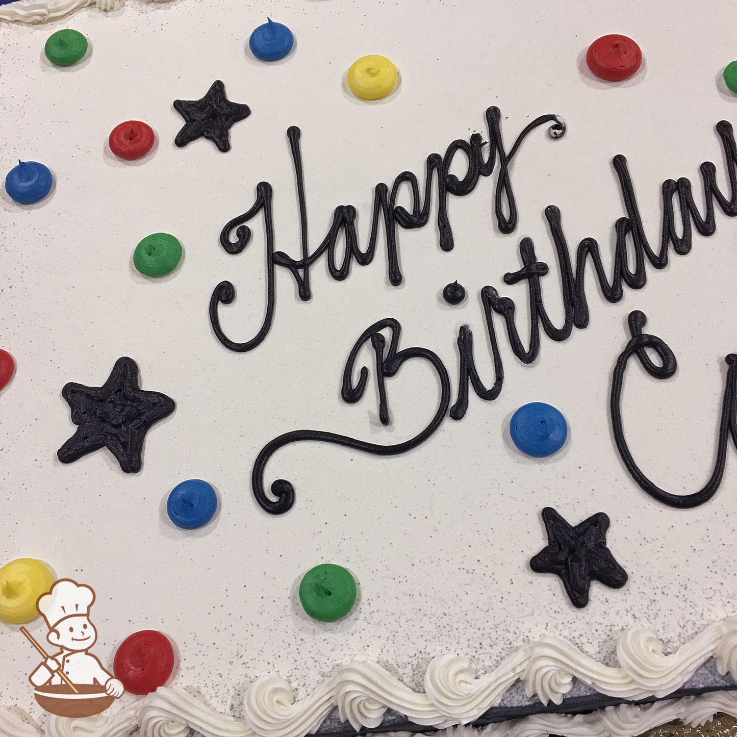 Festive sheet cake with buttercream piped stars and dots.