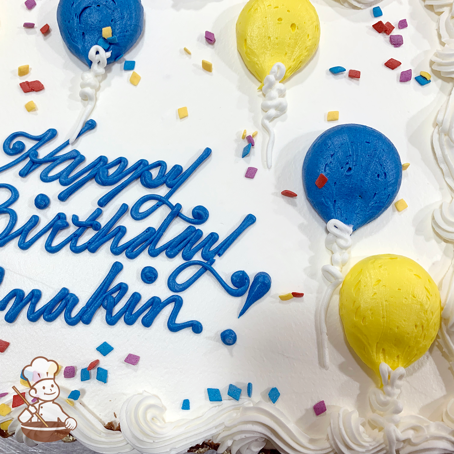 Birthday sheet cake with buttercream balloons and sprinkles.