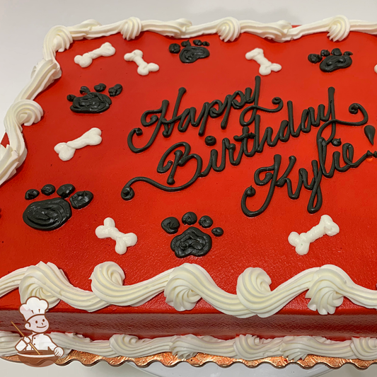 Birthday sheet cake with red icing, black animal dog paws and white bones.