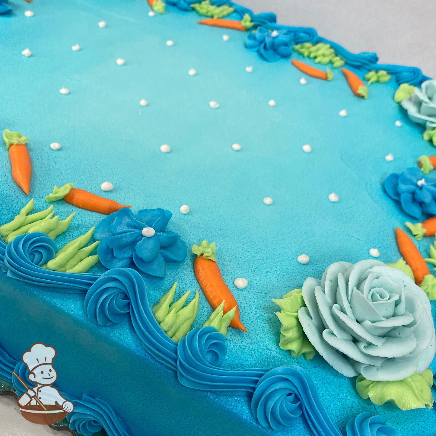 Celebration sheet cake with buttercream roses, flowers, and carrots.