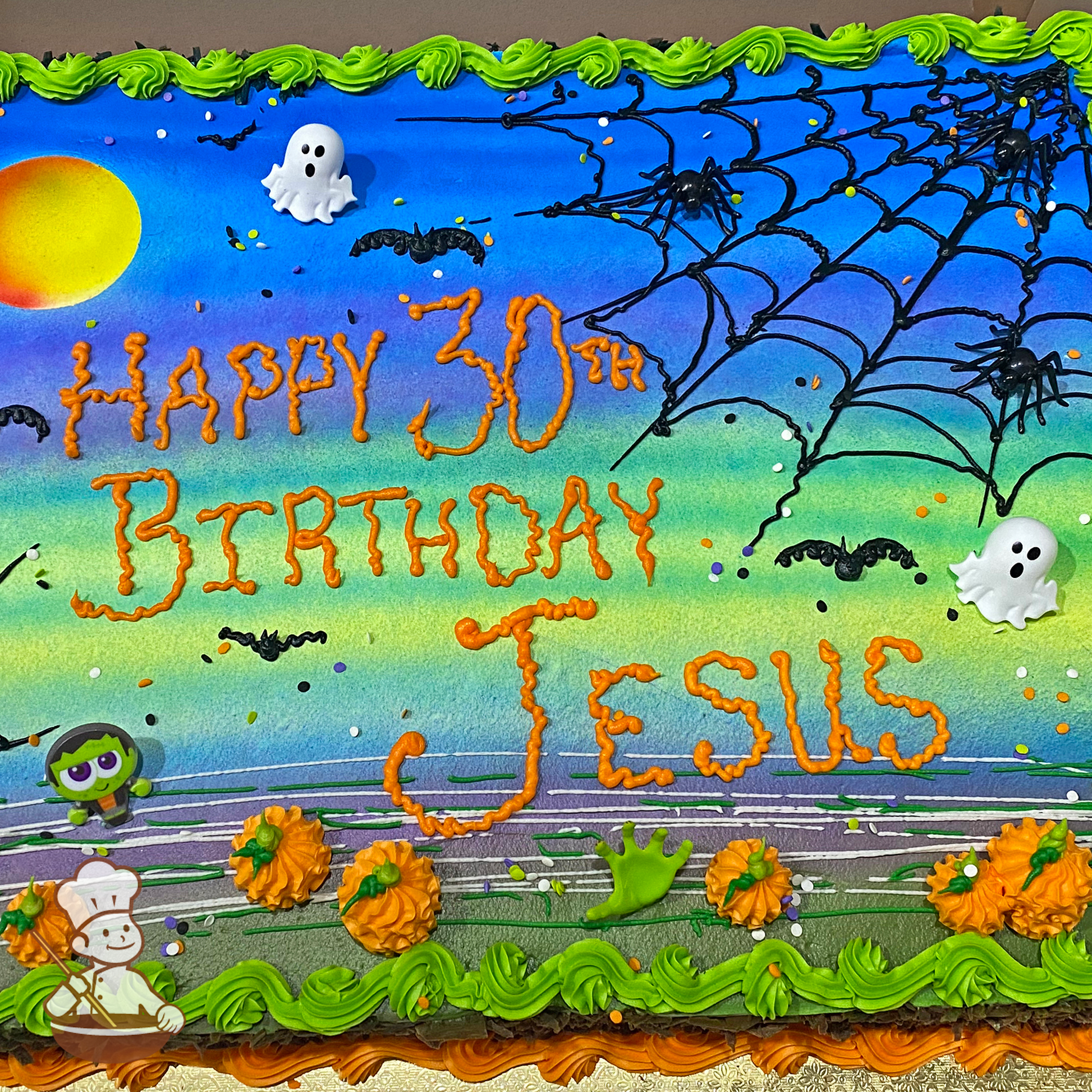 Sheet cake with spiders, bat, pumpkins; neon glow night sky and full moon sprayed on with ghost and frankenstein toy rings.