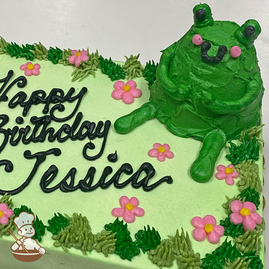 Birthday sheet cake with buttercream daisies and grass with edible ugly frog.