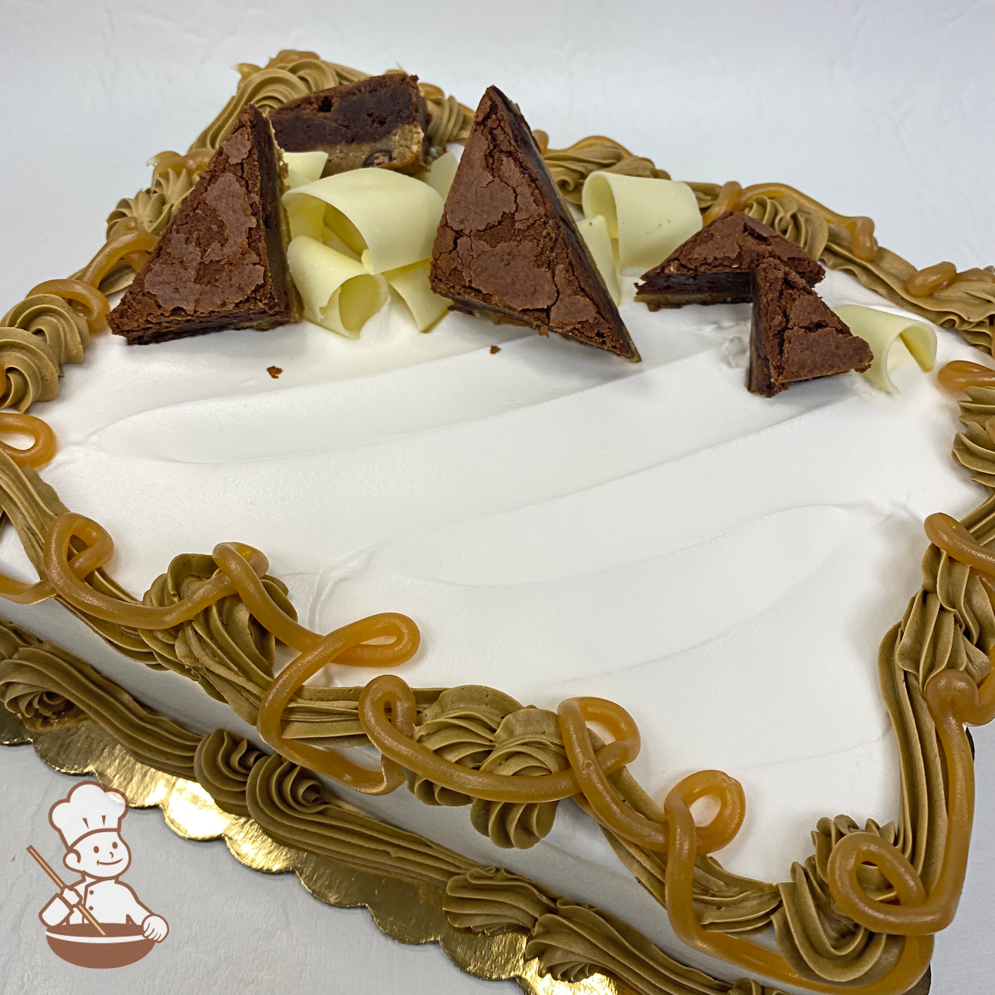 Sheet cake with chocolate brownies and white chocolate curls and caramel drizzle.