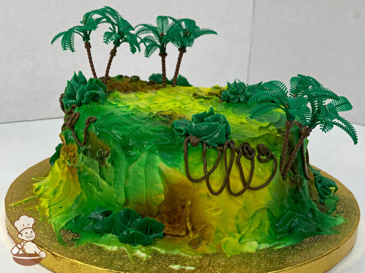 Single tier cake decorated with green and brown buttercream with added texture and piped buttercream vines and plastic palm trees.