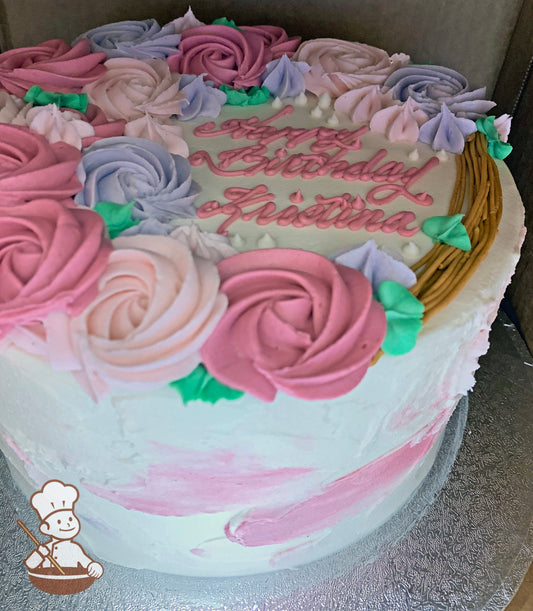 Single tier cake with a white and pink watercolor texture and decorated with buttercream rosettes in mauve, light-pink and lavender colors.