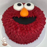 Single tier cake decorated to look like Elmo's face.