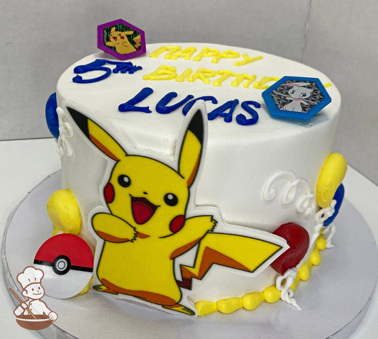 Cake with white icing, decorated with a printed Pikachu in front of the cake, plastic Pokémon-themed rings and festive buttercream balloons.