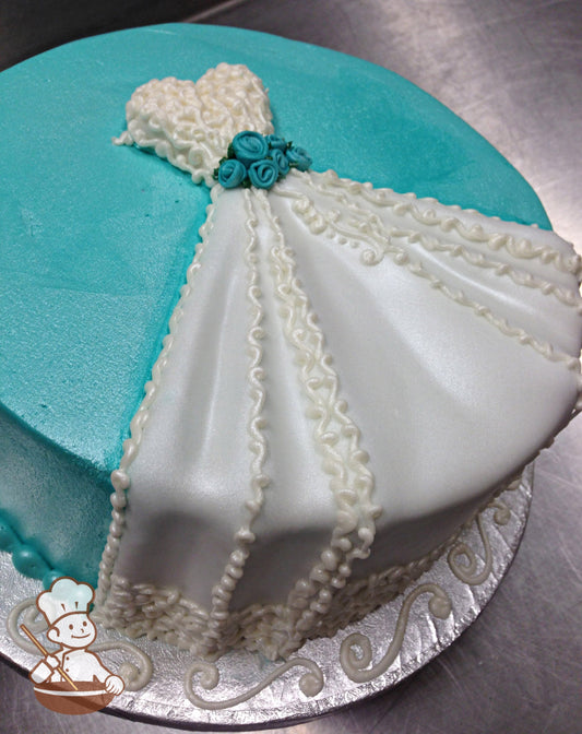Cake with tiffany-blue icing, and decorated with a white fondant wedding dress sitting flat on top of the cake then cascading over the tier.