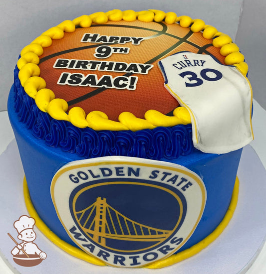Cake decorated with the Golden State Warriors logo and a printed image of a basketball on top of the cake with a fondant Steph Curry jersey.