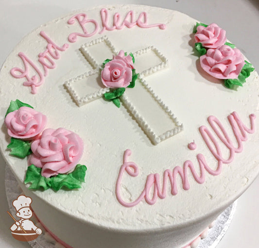 Single tier cake with smooth white icing and decorated with light-pink buttercream roses and a white cross on top of the cake.
