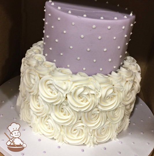 2-tier round cake with white buttercream rosettes on the bottom tier and smooth lavender icing on the top tier with white buttercream dots.