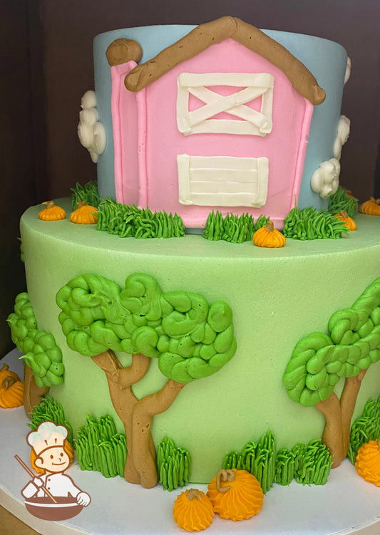 2-tier round cake with green icing and buttercream tress and pumpkins on the bottom tier and blue icing with a pink farm on the top tier.