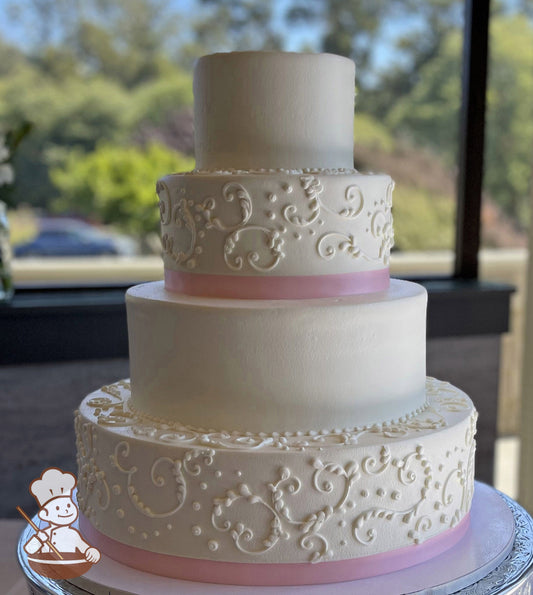 4-tier round cake with white icing, has scrolls and a pink ribbon on the bottom and third tiers, the second and top tier have smooth white icing.