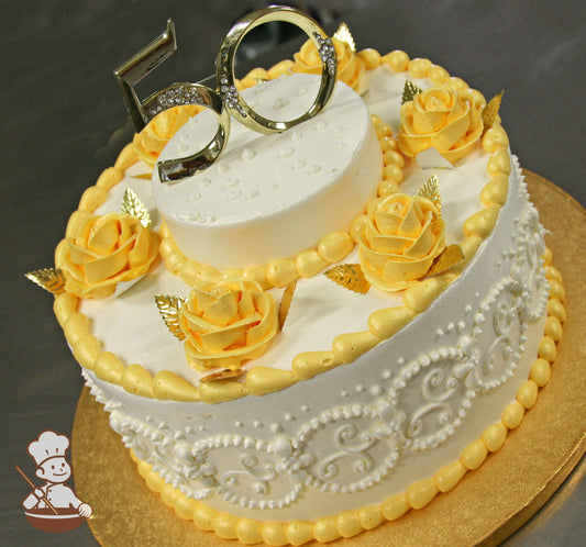 Single tier round cake with white icing and white scrolls on cake wall. The cake also yellow-gold buttercream roses with metallic gold leaves.