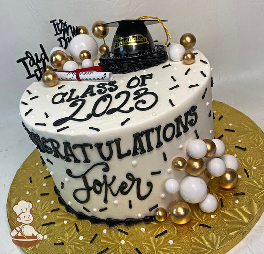 Single tier round cake with white icing and a black graduation cap and white, black and gold decorations including balloons and a paper diploma.