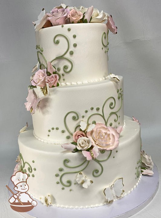 3-tier cake with smooth white icing, and decorated with sugar roses & butterflies in pink and lavender colors with gold accents.