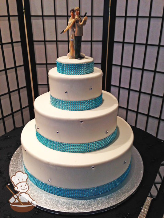 3-tier cake with smooth white icing and a turquoise rhinestone band on the base of the tiers and diamond crystals randomly placed on the tiers.