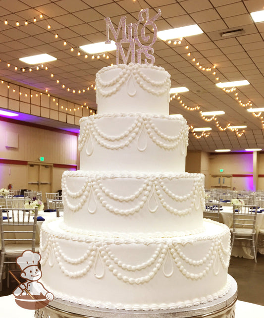 4-tier cake with smooth white icing and white buttercream piping's.