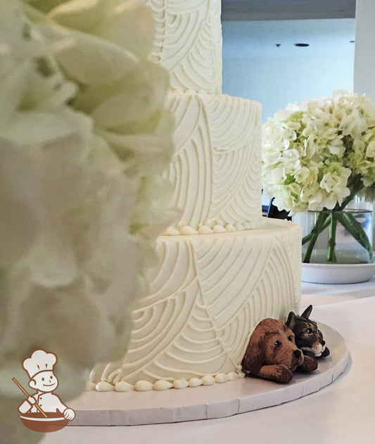 3 Tier wedding cake with vintage curved line piping.  Peek-a-boo dog figurines added for touch of whimsy.