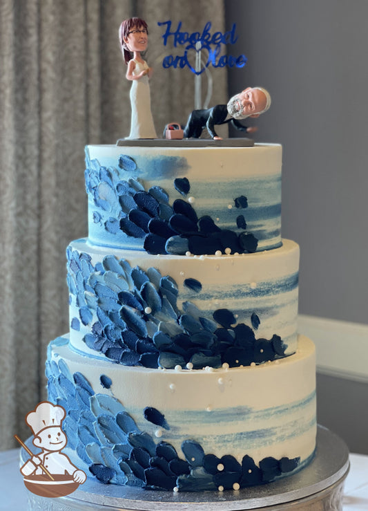 3-tier white cake with blue streaks and scale piping to mimic the ocean waves. Added white sugar balls for bubble effect.