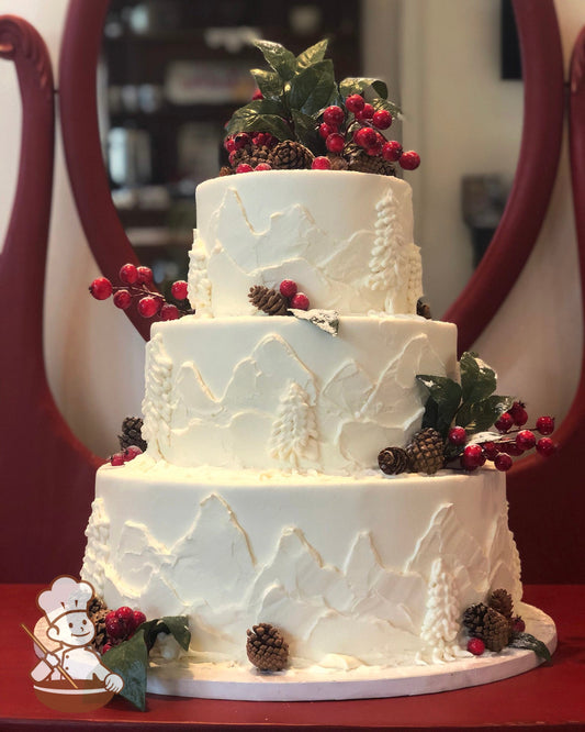 3-tier white cake with painted white mountain peaks painted.