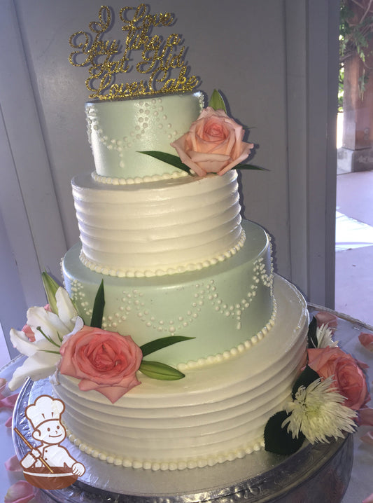 4-tier cake with white icing on the bottom and third tier and decorated with a horizontal texture and mint-green icing on second and top tier.