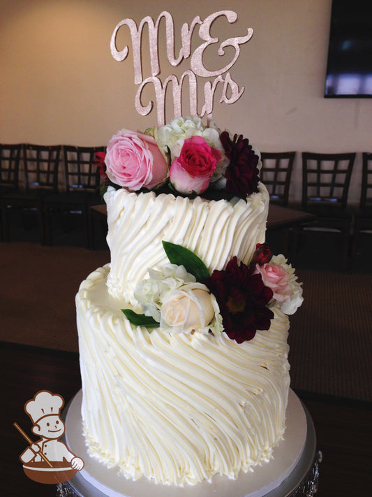 2-tier cake decorated with thick piped white buttercream in a diagonal direction.