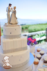3 tier round and square fondant wedding cake with vertical fondant stripes, quilted patterns and rhinestone decoration.